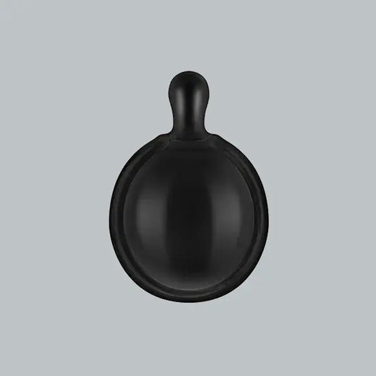 Black ceramic bowl with handle on a light gray background