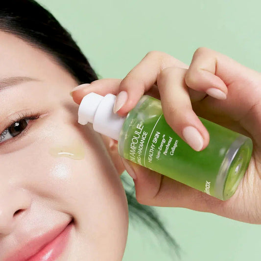 Person applying a green skincare serum to their face with a green background