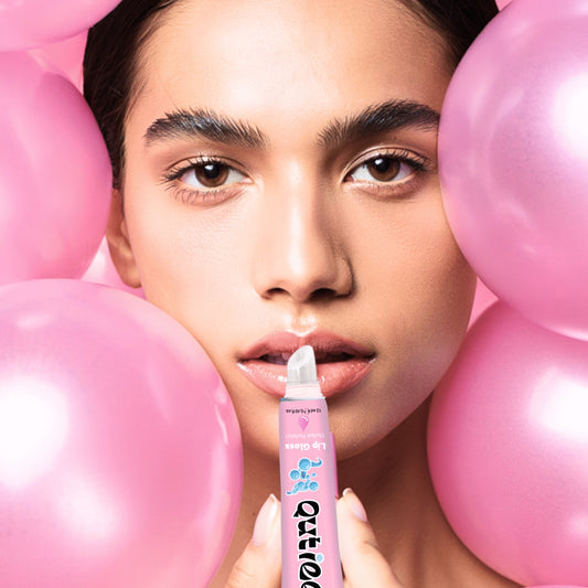 Woman holding a pink lip balm with balloons in the background