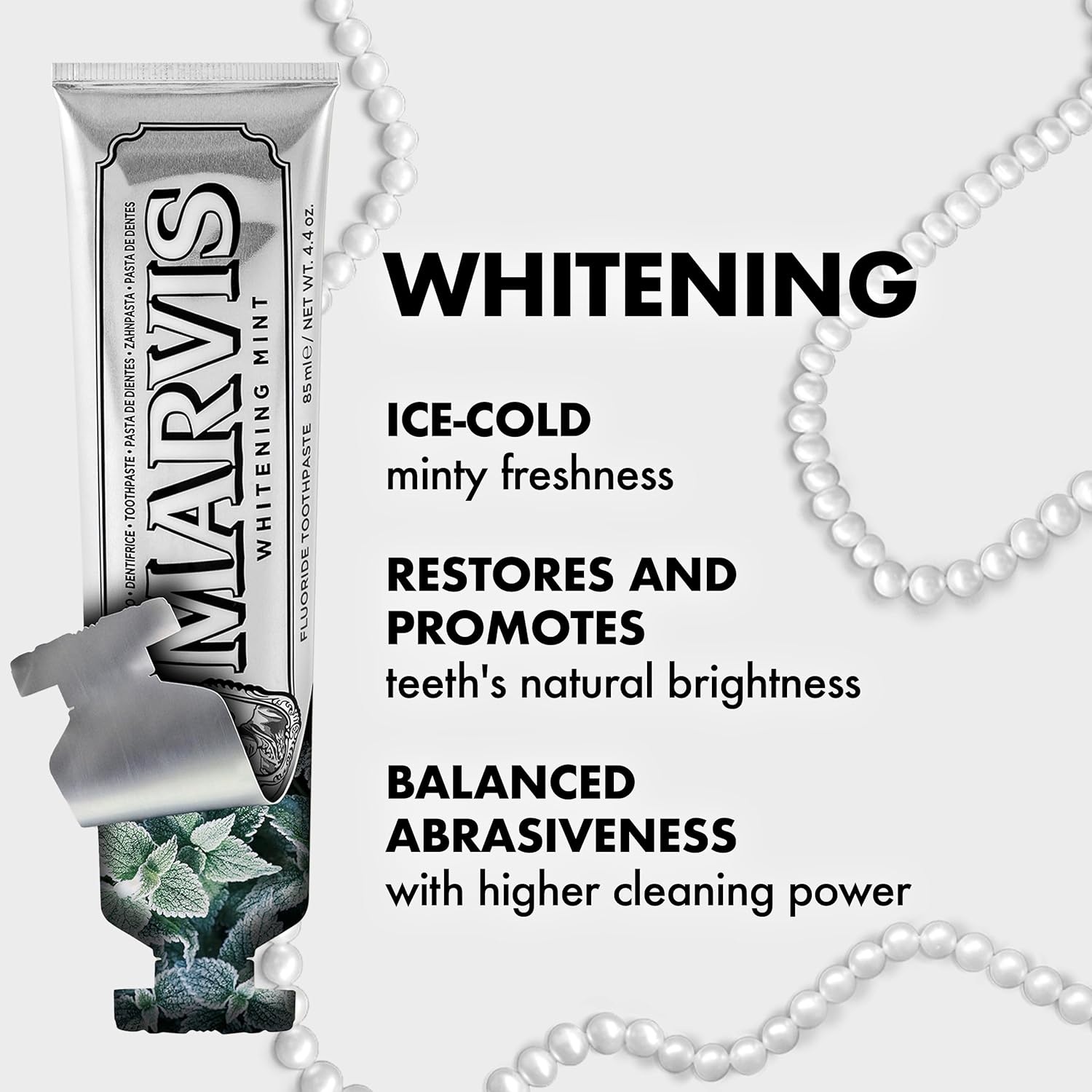 Marvis whitening toothpaste tube with pearl necklace on a white background