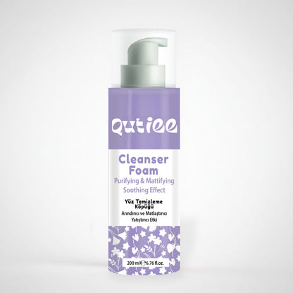 Qutiee Cleanser Foam bottle with purple and white design on a light gray background