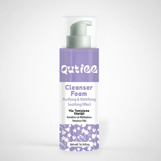 Qutiee Cleanser Foam bottle with purple and white design on a light gray background