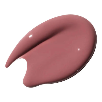 Nude-colored lip gloss swatch on a white background