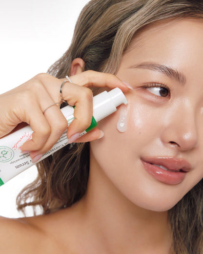 Person applying a skincare product to their face with a close-up view.