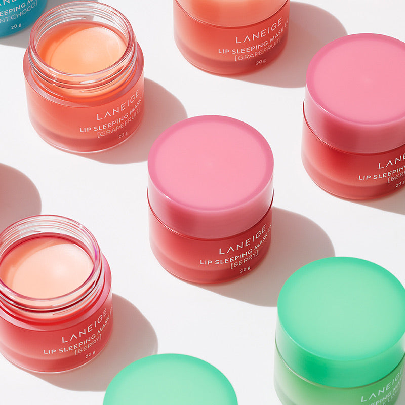 Multiple jars of Laneige lip sleeping masks in various colors on a light background