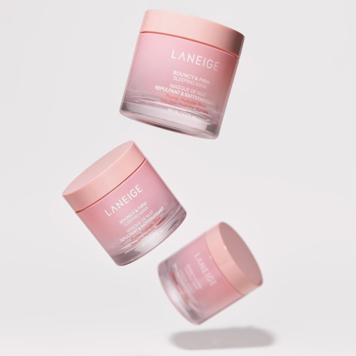 Three pink Laneige skincare jars on a light gray background