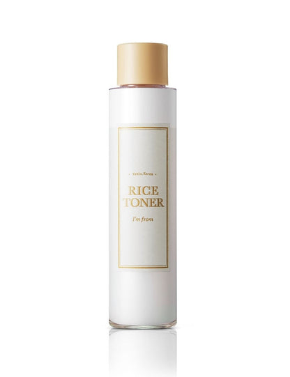 White bottle of rice toner with gold cap on a white background