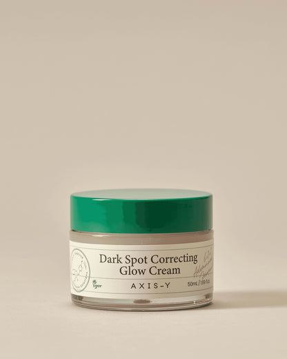 Jar of Axis-Y Dark Spot Correcting Glow Cream on a beige background