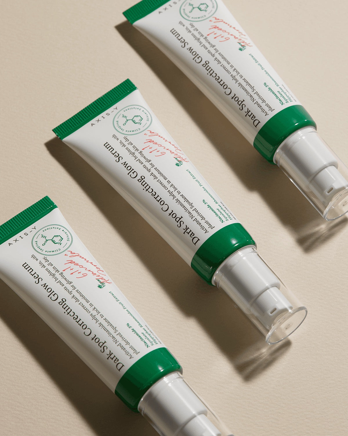 Two tubes of Dark sport correction axis-y Skin Care Cream on a beige background