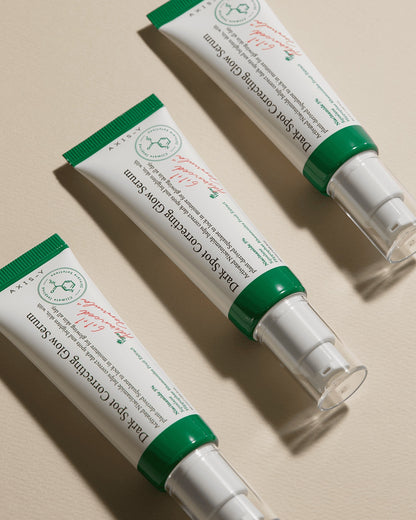 Two tubes of Dark sport correction axis-y Skin Care Cream on a beige background