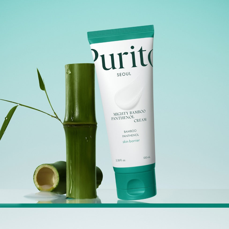 Tube of Purito Mighty Bamboo Panthenol Cream with a bamboo stick on a light blue background