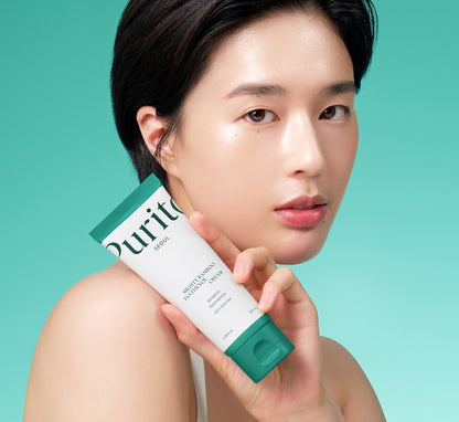 Woman holding a Purito skincare product against a teal background