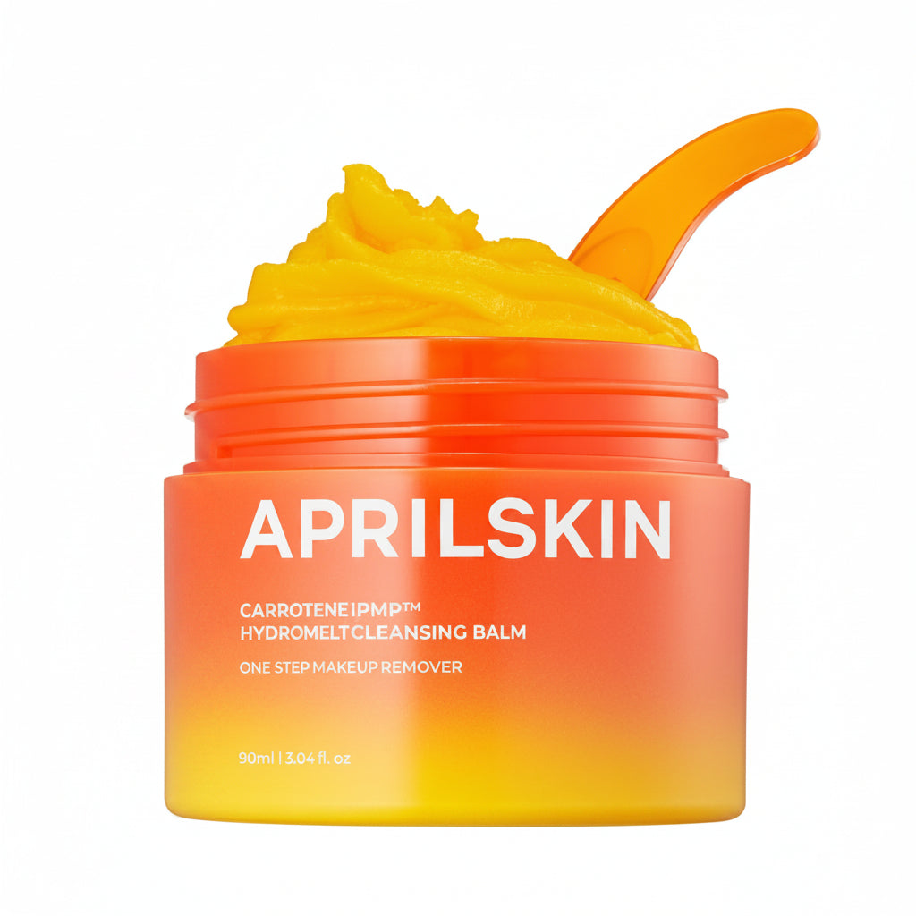 Aprilskin cleansing balm jar with yellow cream and orange lid on a white background