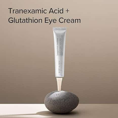 Tube of Tranexamic Acid + Glutathion Eye Cream on a stone with a beige background