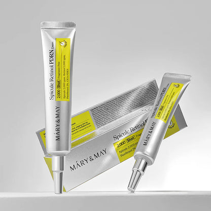 Two skincare serum tubes with a box on a gray background