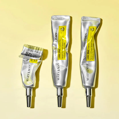 Three tubes of Mary & May eye cream on a yellow background