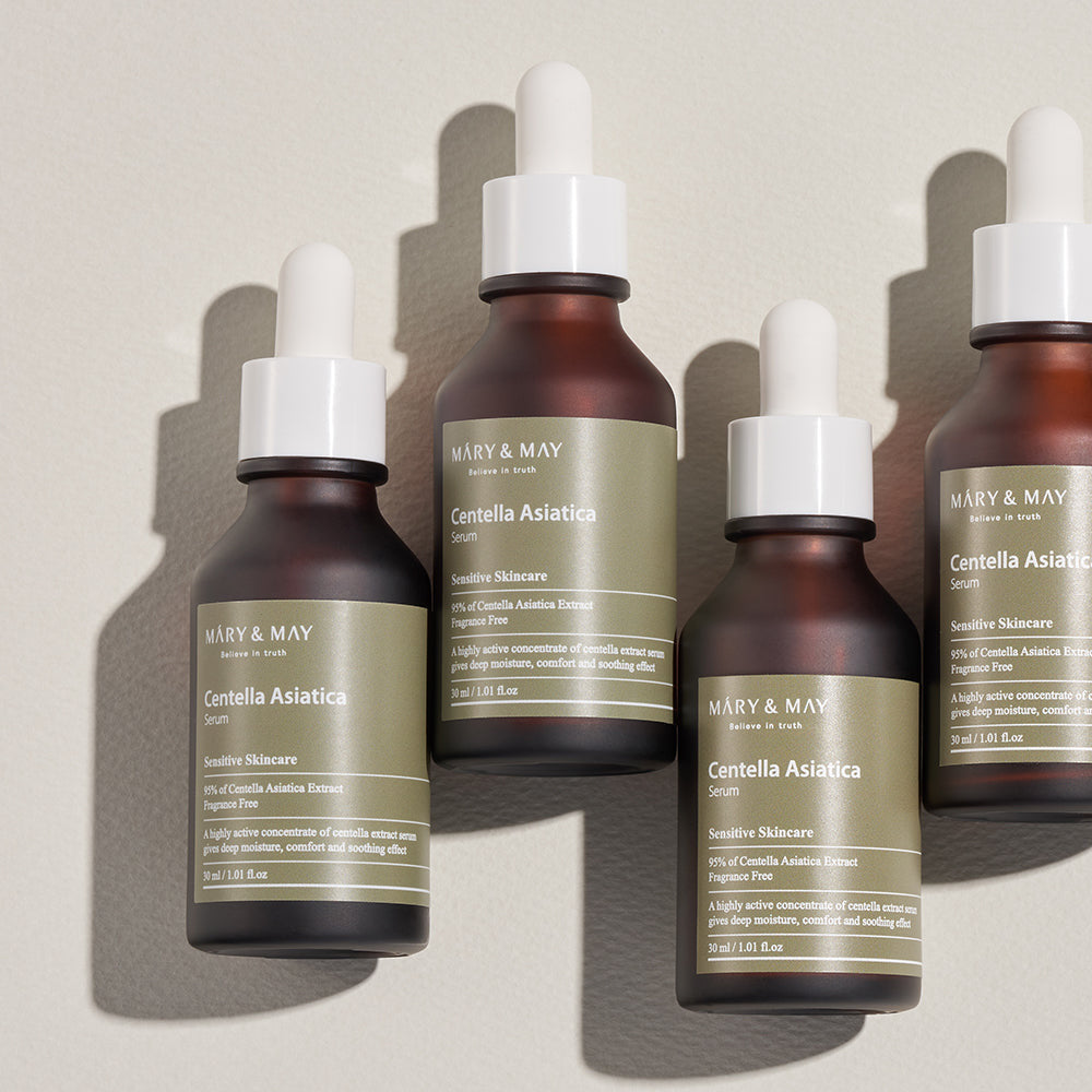 Four bottles of Mary & May Centella Asiatica serum on a light background