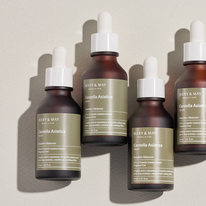 Four bottles of Mary & May Centella Asiatica serum on a light background