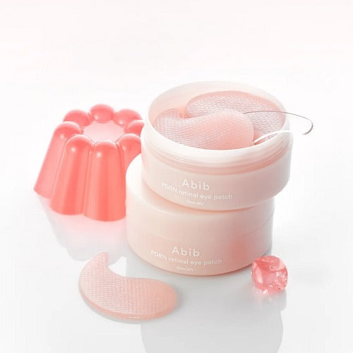 Pink eye patch container with eye patches on a white background