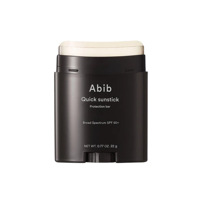 Black sunstick container with white lid labeled 'Abib Quick sunstick' on a white background