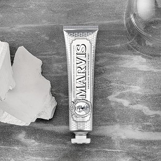 Marvis toothpaste tube on a stone surface